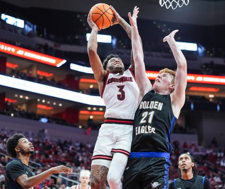 Louisville Cardinals guard Koren Johnson (3) gets two plus the foul against Spalding University's Levi Langley