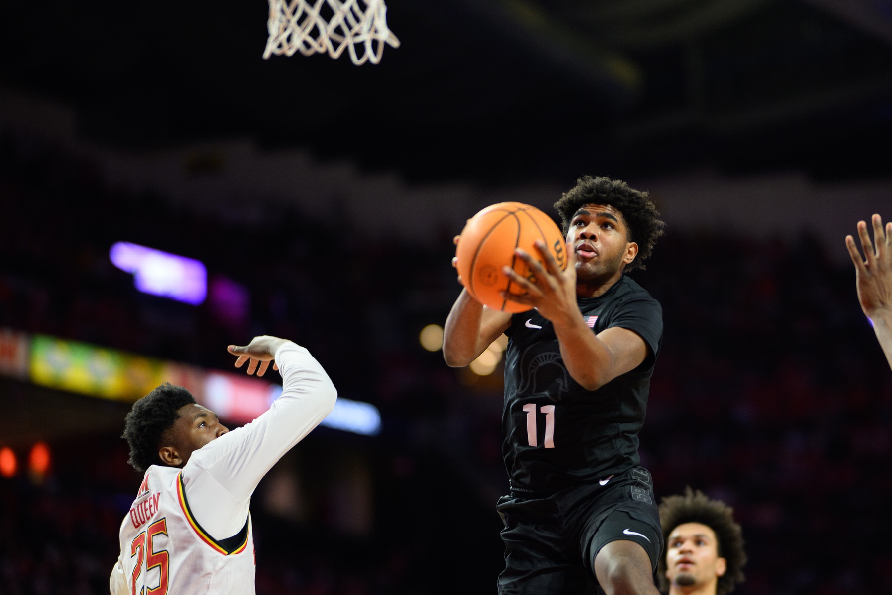 Michigan State Spartans guard Jase Richardson (11) drives to the basket against Maryland Terrapins center Derik Queen (25) during the first half at Xfinity Center.