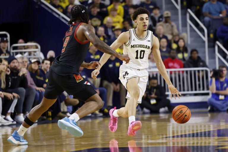 Michigan Wolverines guard Justin Pippen (10) dribbles defended by Maryland Terrapins guard Selton Miguel (9) in the first half at Crisler Center.