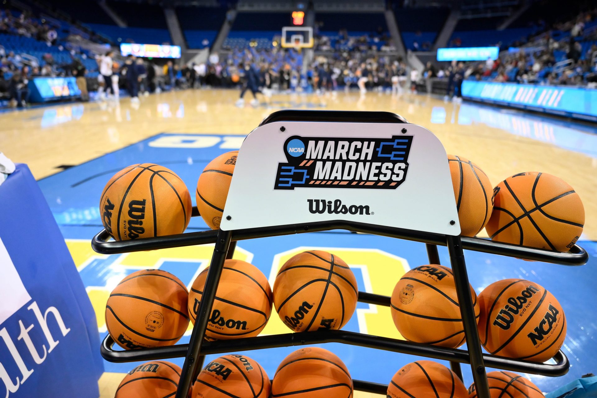 A rack of basketballs with the March Madness logo