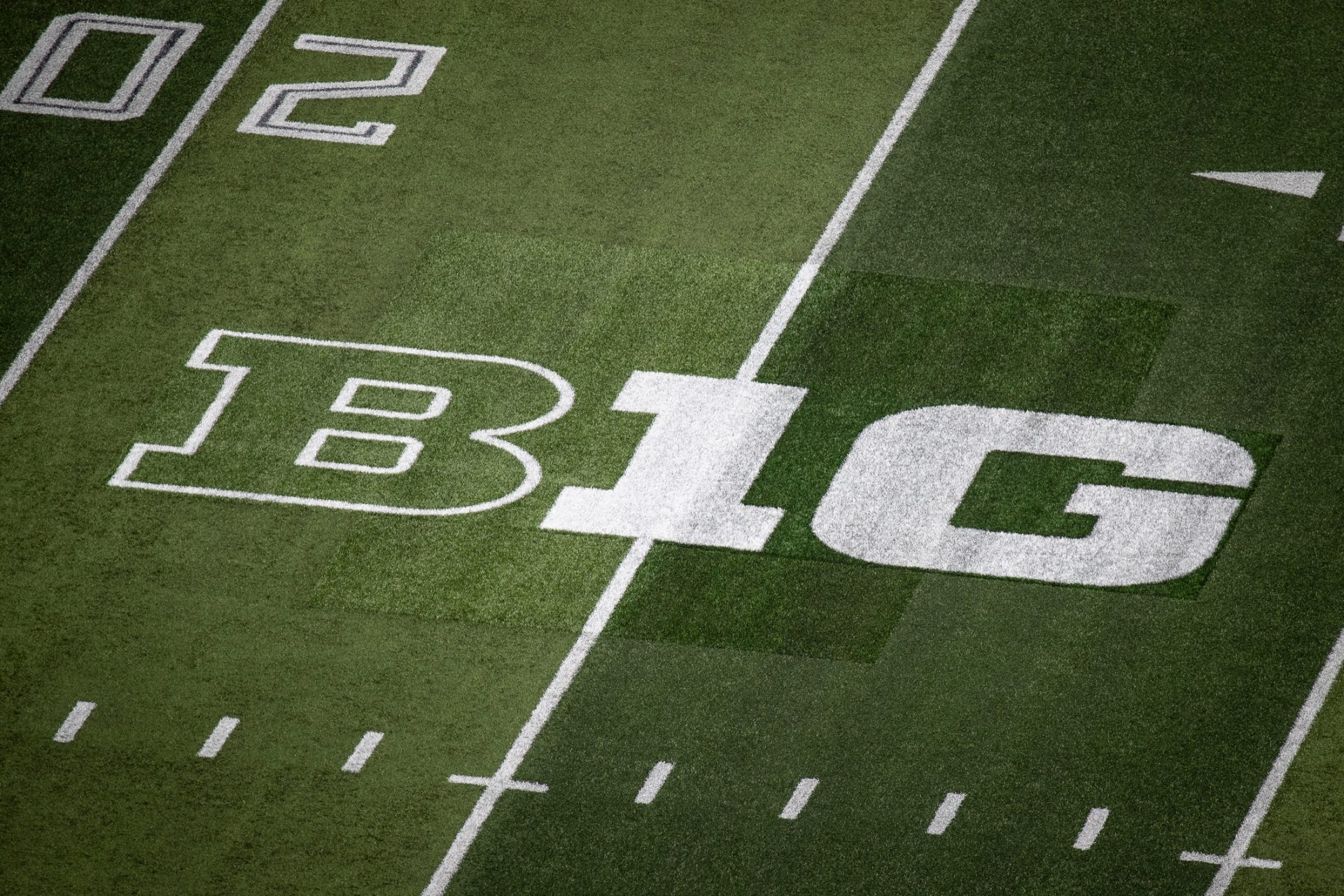 A patchwork of turf surrounds the Big Ten logo where it replaced the Pac-12 logo on the field at Autzen Stadium