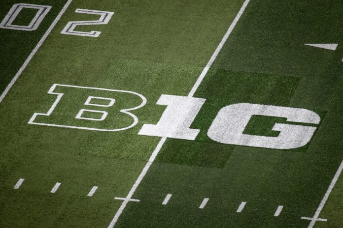 A patchwork of turf surrounds the Big Ten logo where it replaced the Pac-12 logo on the field at Autzen Stadium