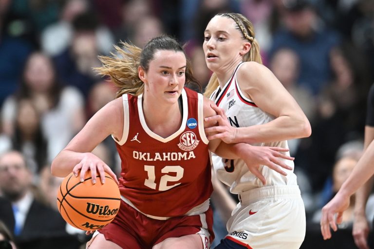 Oklahoma Sooners guard Payton Verhulst (12) controls the ball against UConn Huskies guard Paige Bueckers (5) during the first half of a Sweet 16 NCAA Tournament basketball game at Spokane Arena. at Spokane Arena.