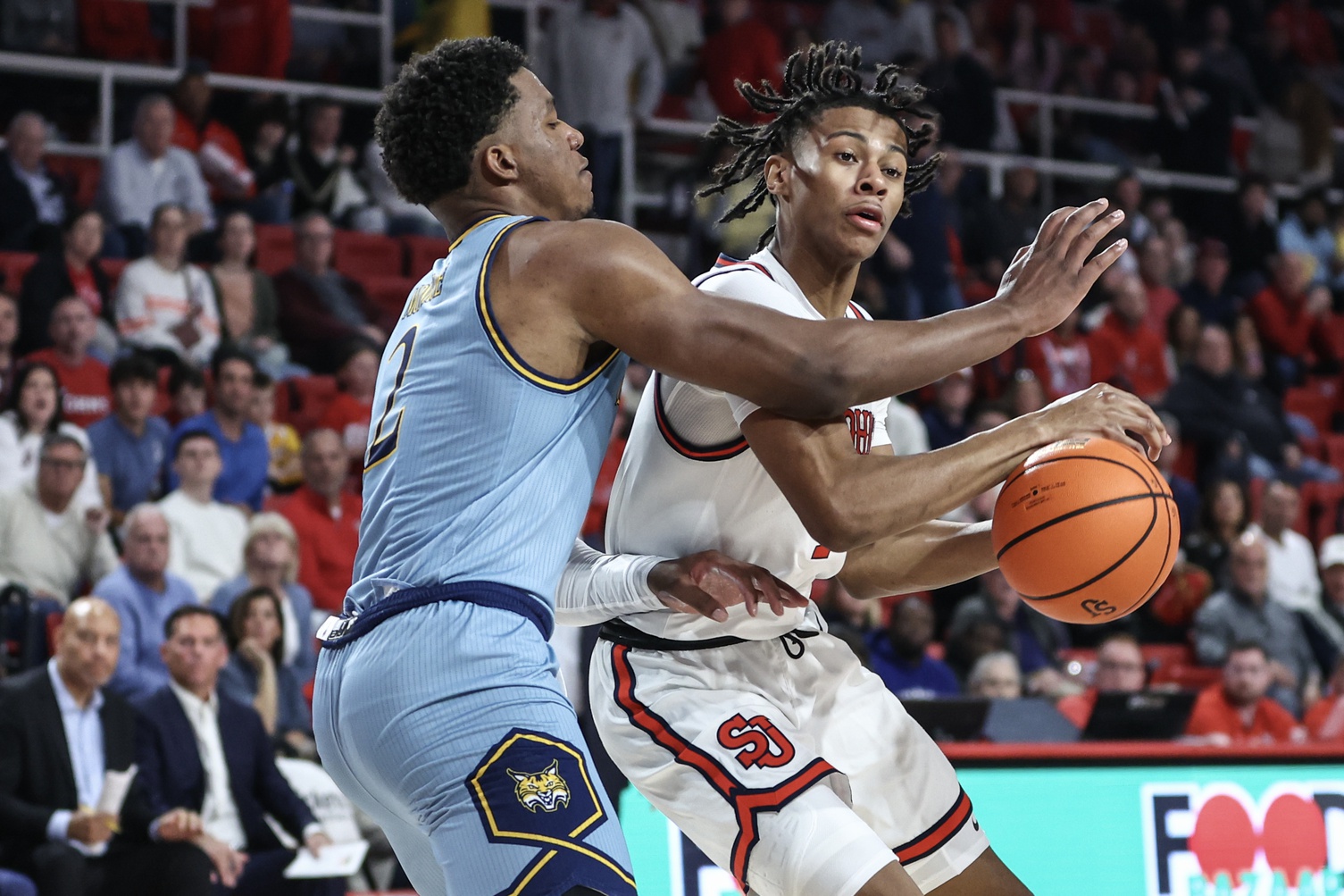 St. John's Red Storm guard Simeon Wilcher (7) looks to drive past Quinnipiac Bobcats forward Amarri Monroe (2) in the second half at Carnesecca Arena.