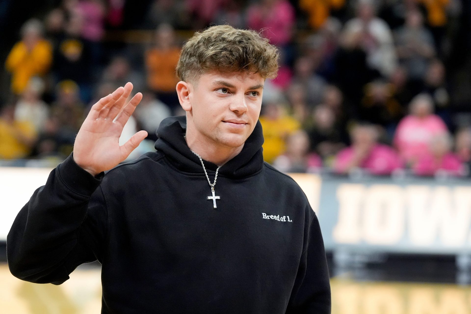 Former Iowa football player and Super Bowl LIX champion Cooper DeJean is interviewed on court during halftime of the Iowa women’s basketball game against UCLA