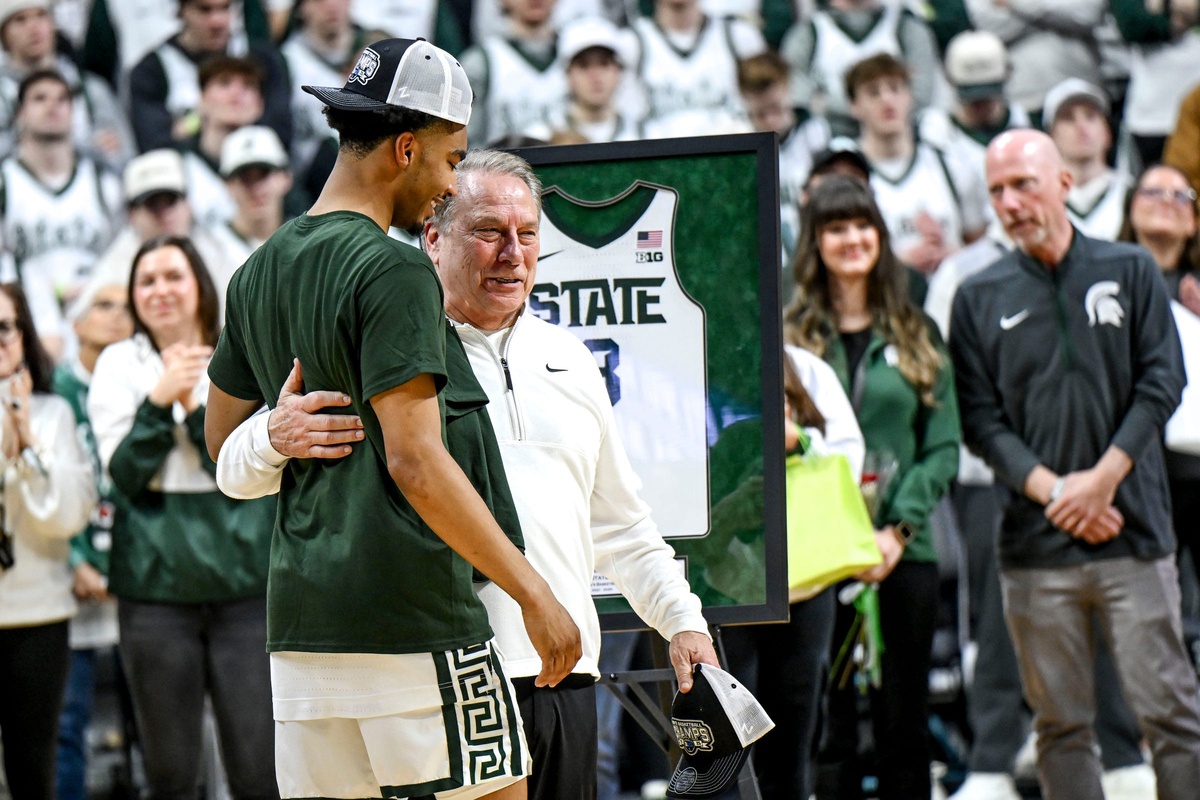 Michigan State senior Jaden Akins, left, hugs head coach Tom Izzo after the game against Michigan on Sunday