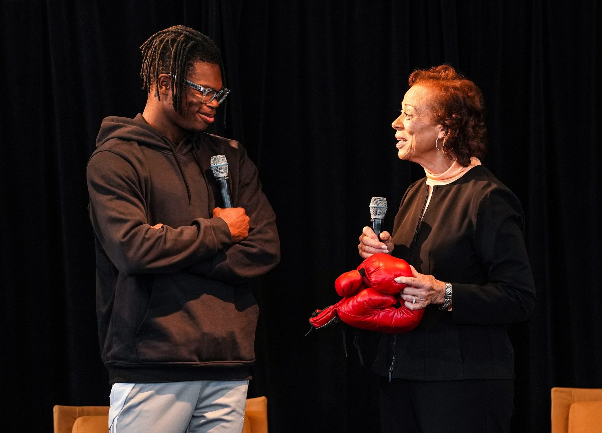 Lonnie Ali, Muhammad Ali's widow, presented from her own collection boxing gloves signed by the legendary boxer himself, to Travis Hunter at the Muhammad Ali Center