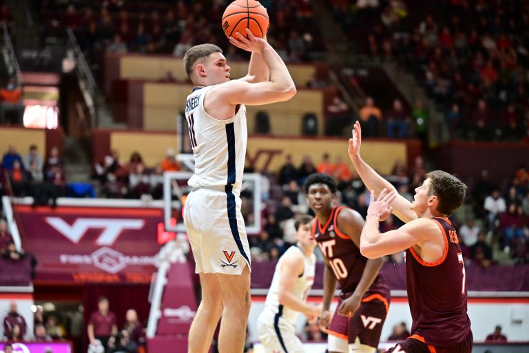 Virginia Cavaliers guard Isaac McKneely (11) shoots a jump shot as Virginia Tech Hokies guard Brandon Rechsteiner (7) defends at Cassell Coliseum.