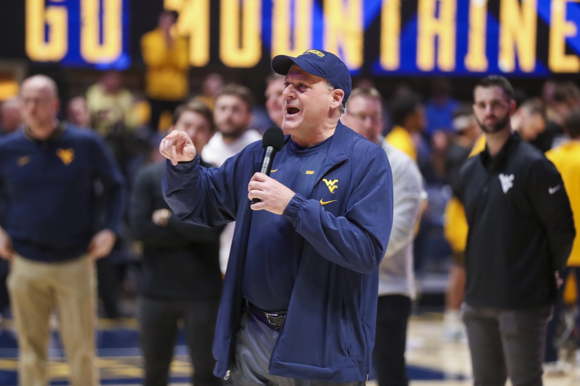 West Virginia, USA; West Virginia Mountaineers head football coach Rich Rodriguez speaks to the crowd during a timeout during the first half against the Cincinnati Bearcats at WVU Coliseum.