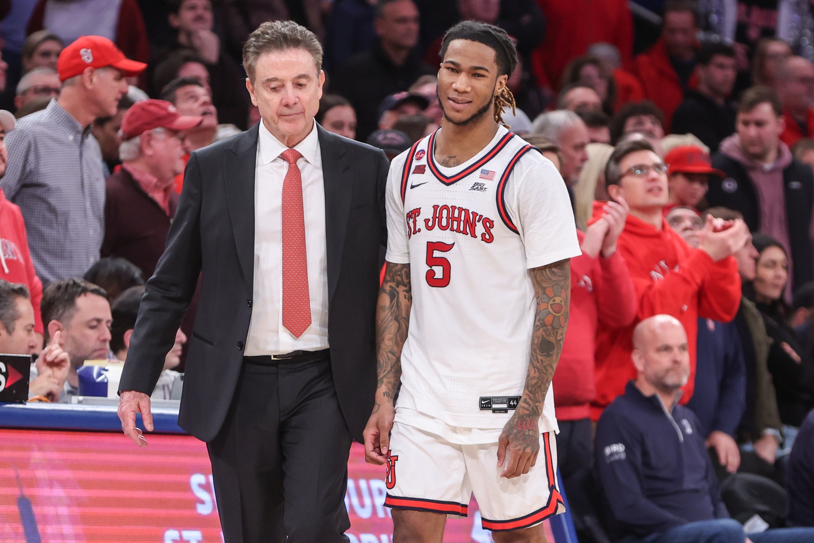 St. John's Red Storm guard Deivon Smith (5) walks to the bench with head coach Rick Pitino in the second half against the Creighton Bluejays at Madison Square Garden.