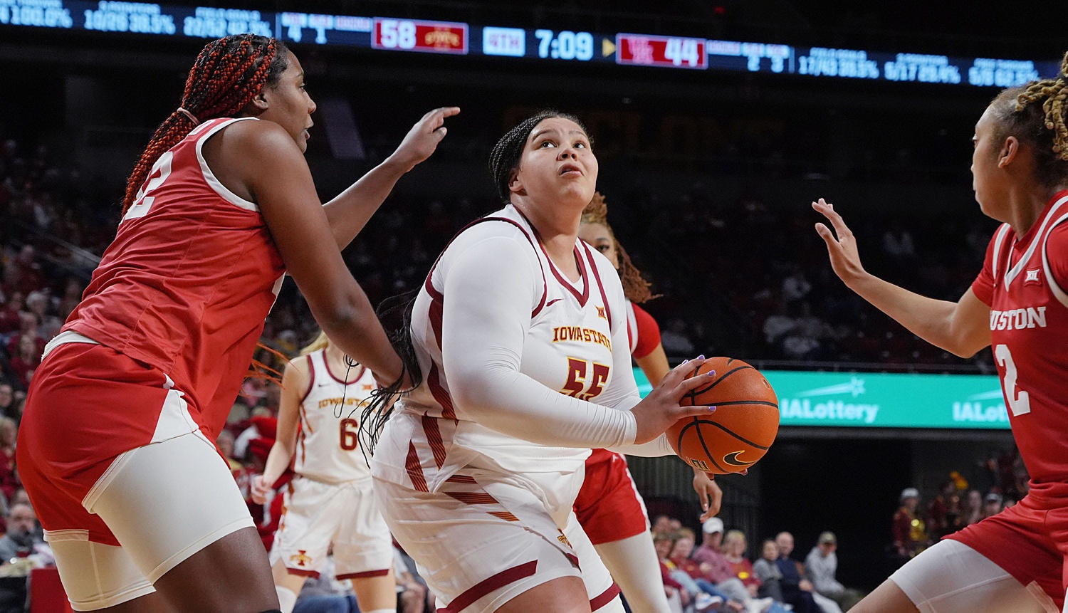 Iowa State Cyclones' center Audi Crooks (55) looks for a shot between Houston Cougars forward Peyton McFarland (42) and guard Kierra Merchant (2) during the fourth quarter in the Big-12 women’s basketball at Hilton Coliseum