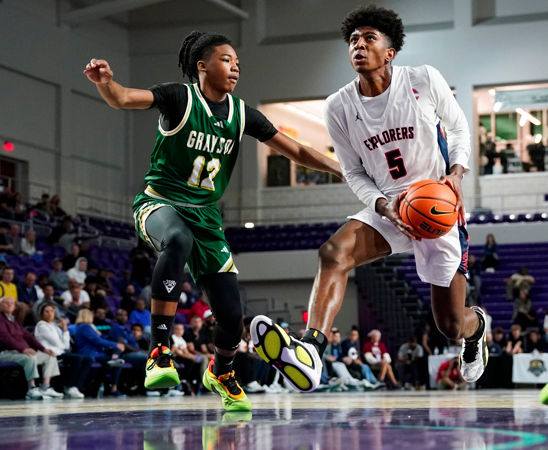 Columbus Explorers guard Jaxon Richardson (5) drives to the basket as Grayson Rams guard Blaze Johnson (12) guards him during the third quarter of a City of Palms Classic quarterfinal game