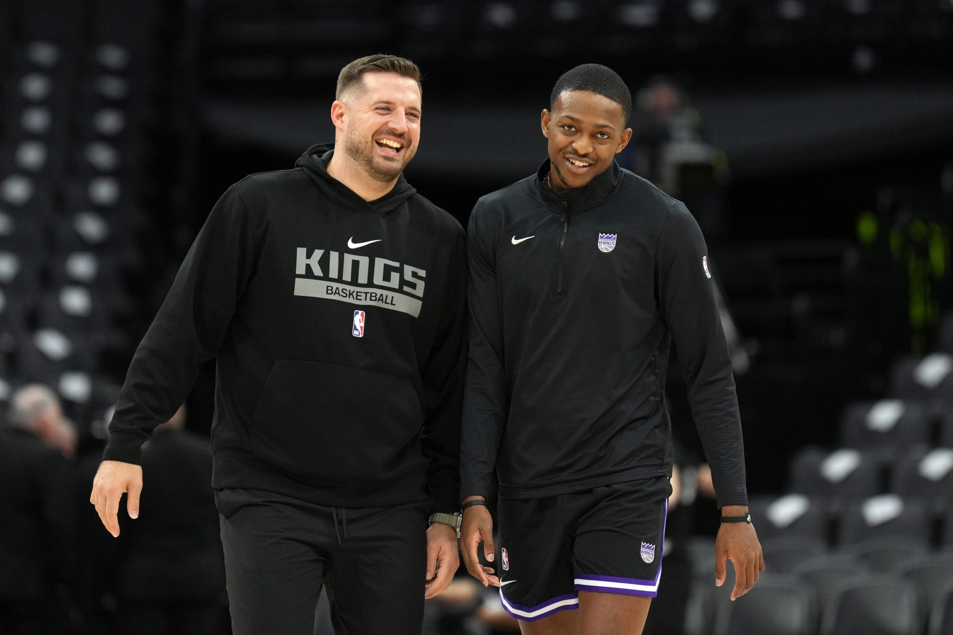 Sacramento Kings guard De'Aaron Fox (right) and assistant coach Luke Loucks (left) talk before the game against the Brooklyn Nets at Golden 1 Center.