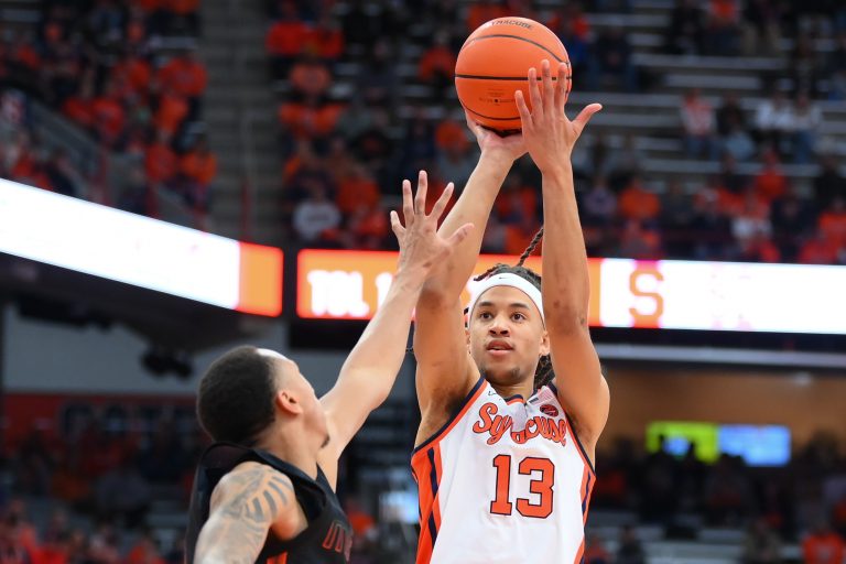 Syracuse Orange forward Benny Williams (13) shoots the ball as Miami (Fl) Hurricanes guard Matthew Cleveland (left) defends during the second half at the JMA Wireless Dome.