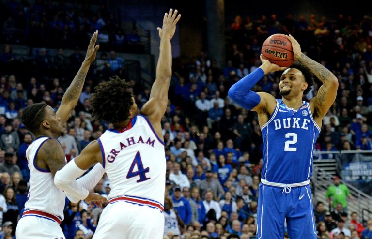 Duke Blue Devils guard Gary Trent Jr. (2) shoots the ball against Kansas Jayhawks guard Devonte' Graham (4) during the first half in the championship game of the Midwest regional of the 2018 NCAA Tournament at CenturyLink Center.