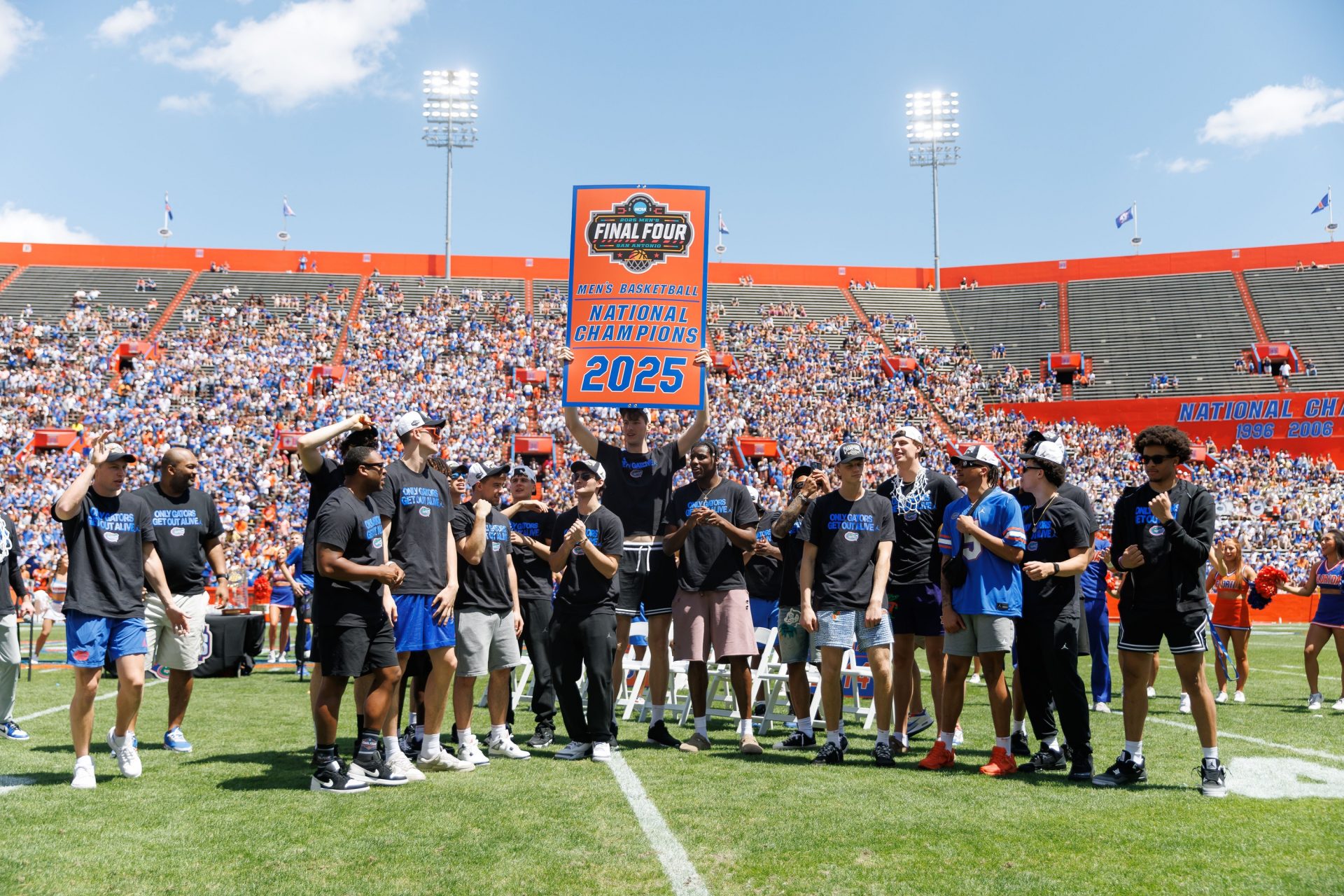 Florida Gators center Olivier Rioux (32) holds the National Championship banner over teammates during the National Championship celebration at Ben Hill Griffin Stadium.