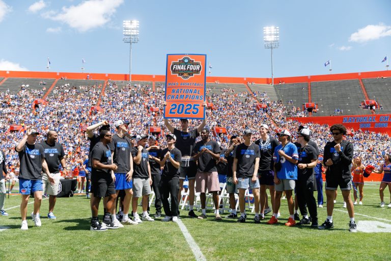 Florida Gators center Olivier Rioux (32) holds the National Championship banner over teammates during the National Championship celebration at Ben Hill Griffin Stadium.