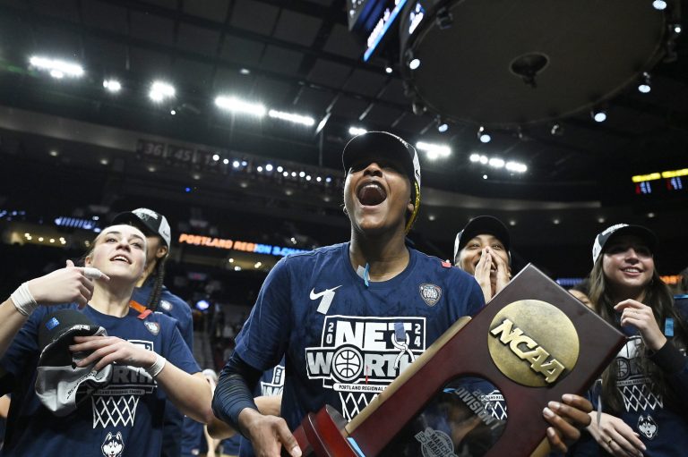 UConn Huskies forward Aaliyah Edwards (3) celebrates with teammates after beating the USC Trojans in the finals of the Portland Regional of the NCAA Tournament at the Moda Center.