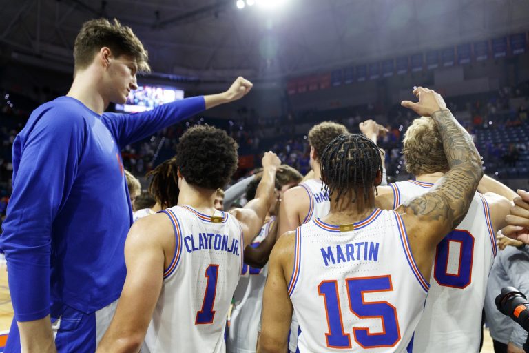 Florida Gators guard Walter Clayton Jr. (1) and center Olivier Rioux (32) and guard Alijah Martin (15) and forward Thomas Haugh (10) huddle after the game against the Texas A&M Aggies at Exactech Arena at the Stephen C. O'Connell Center.