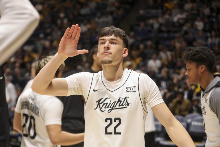 UCF Knights guard Nils Machowski (22) is introduced during starting lineups before their game against the West Virginia Mountaineers at WVU Coliseum.