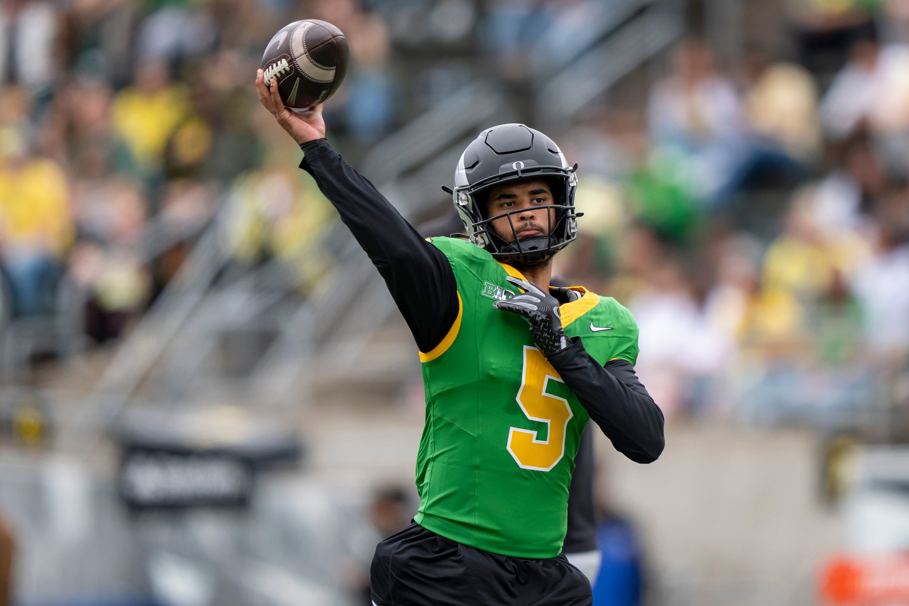 Combat Ducks quarterback Dante Moore throws out a pass as the Fighting Ducks face off against Mighty Oregon in the Oregon Ducks spring game on April 26, 2025, at Autzen Stadium in Eugene.