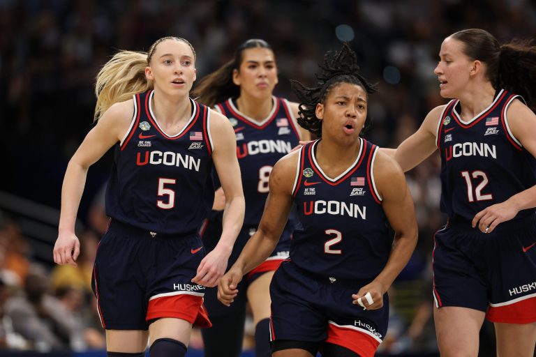 Connecticut Huskies guard Paige Bueckers (5) and guard KK Arnold (2) react during first quarter in a semifinal of the women's 2025 NCAA tournament against the UCLA Bruins at Amalie Arena.