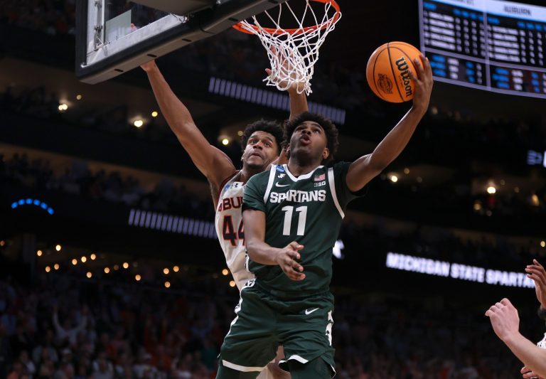 Michigan State Spartans guard Jase Richardson (11) shoots against Auburn Tigers center Dylan Cardwell (44) during the second half in the South Regional final of the 2025 NCAA tournament at State Farm Arena.