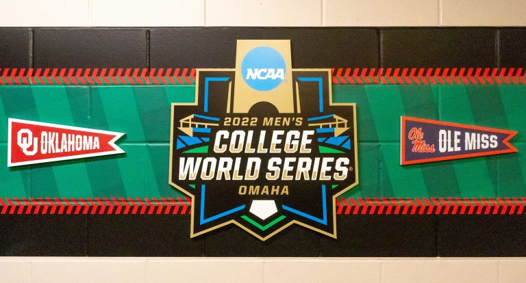 Banners for the Oklahoma Sooners and the Ole Miss Rebels hang with the College World Series logo in a hallway before the game at Charles Schwab Field.