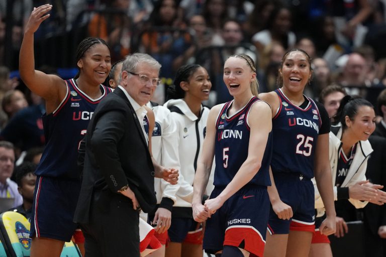 UConn guard Paige Bueckers (5) reacts with head coach Geno Auriemma on the bench during the fourth quarter in a semifinal of the women's 2025 NCAA tournament against the UCLA Bruins at Amalie Arena.