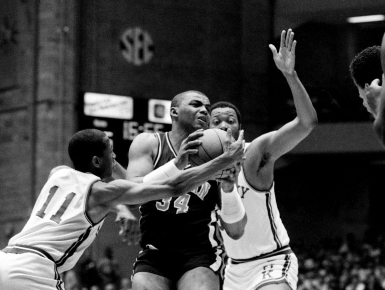 Auburn junior Charles Barkley (34) attracts the attention of Kentucky teammates Dicky Beal (11) and Melvin Turpin, right, in the SEC Tournament championship game on March 10, 1984. Kentucky hits a last second shot to win 51-49.