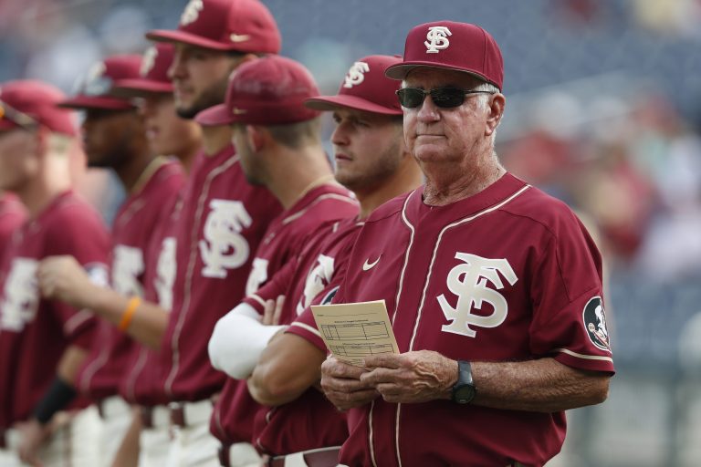 Florida State Seminoles head coach Mike Martin stands on the field with his team prior to the game against the Arkansas Razorbacks in the 2019 College World Series at TD Ameritrade Park.