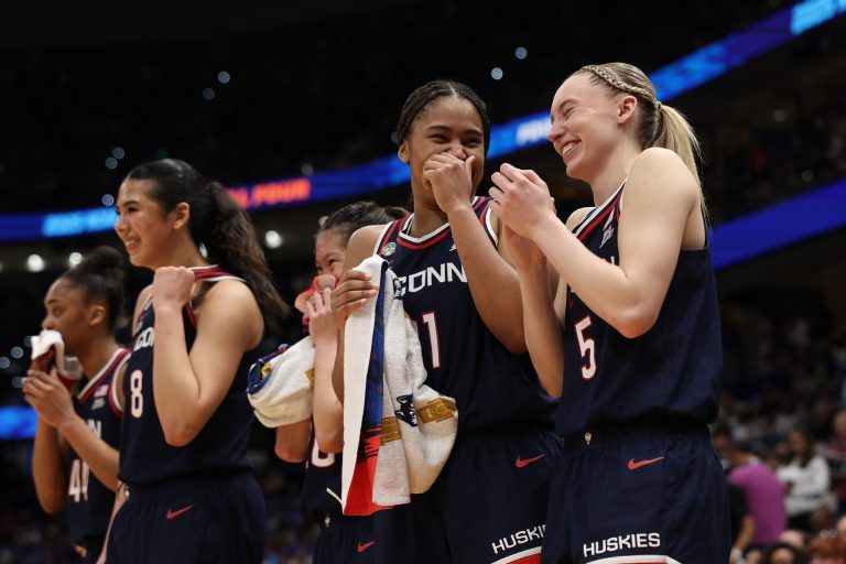 Connecticut Huskies forward Sarah Strong (21) and guard Paige Bueckers (5) react on the bench during the fourth quarter in a semifinal of the women's 2025 NCAA tournament against the UCLA Bruins at Amalie Arena.