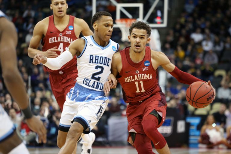 Oklahoma Sooners guard Trae Young (11) drives against Rhode Island Rams guard Fatts Russell (2) during the first half in the first round of the 2018 NCAA Tournament at PPG Paints Arena.