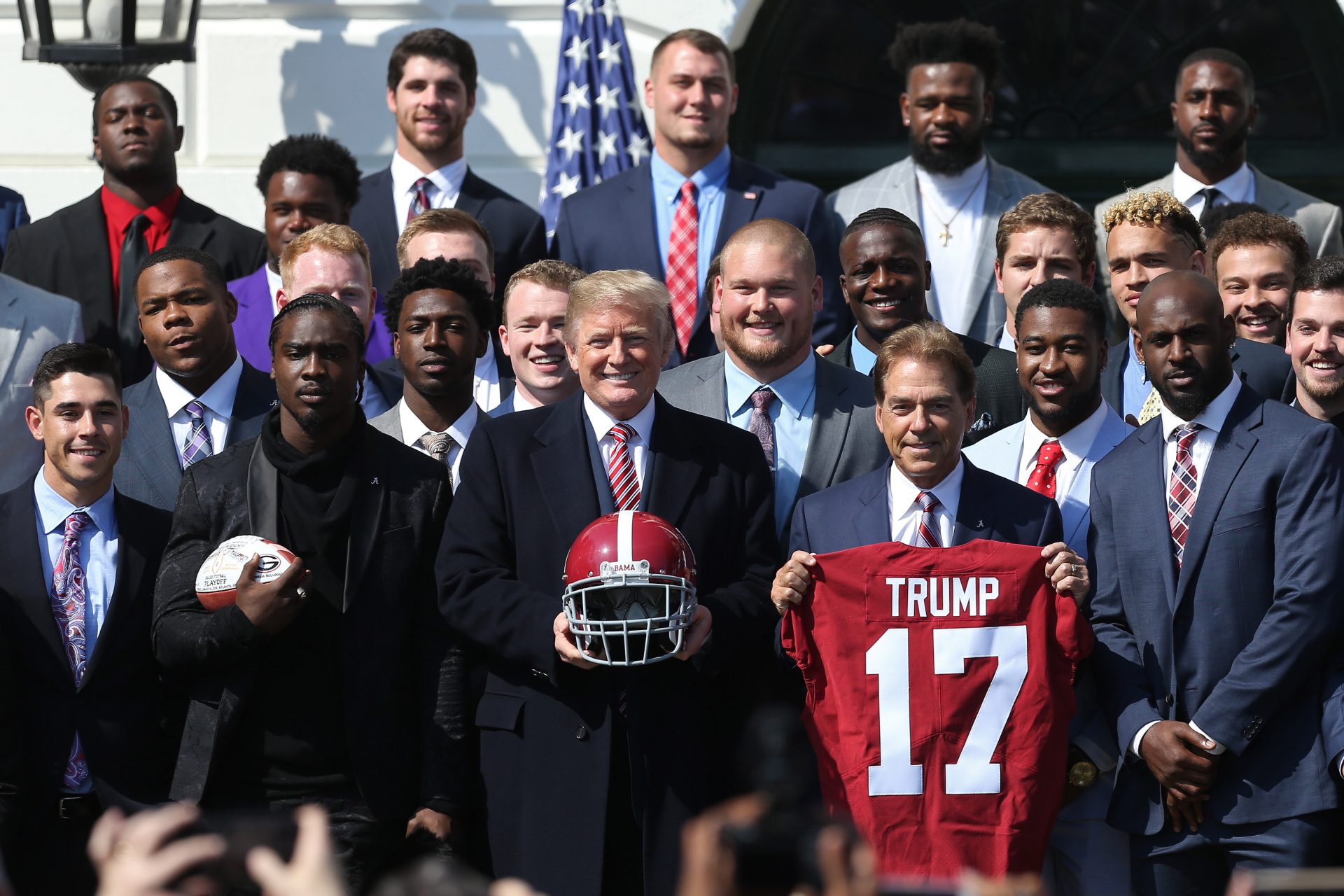 President Donald Trump (M) poses with Alabama Crimson Tide head coach Nick Saban a(M-R) and members of the Crimson Tide a ceremony honoring the college football playoff champion Crimson Tide on the South Lawn at the White House.