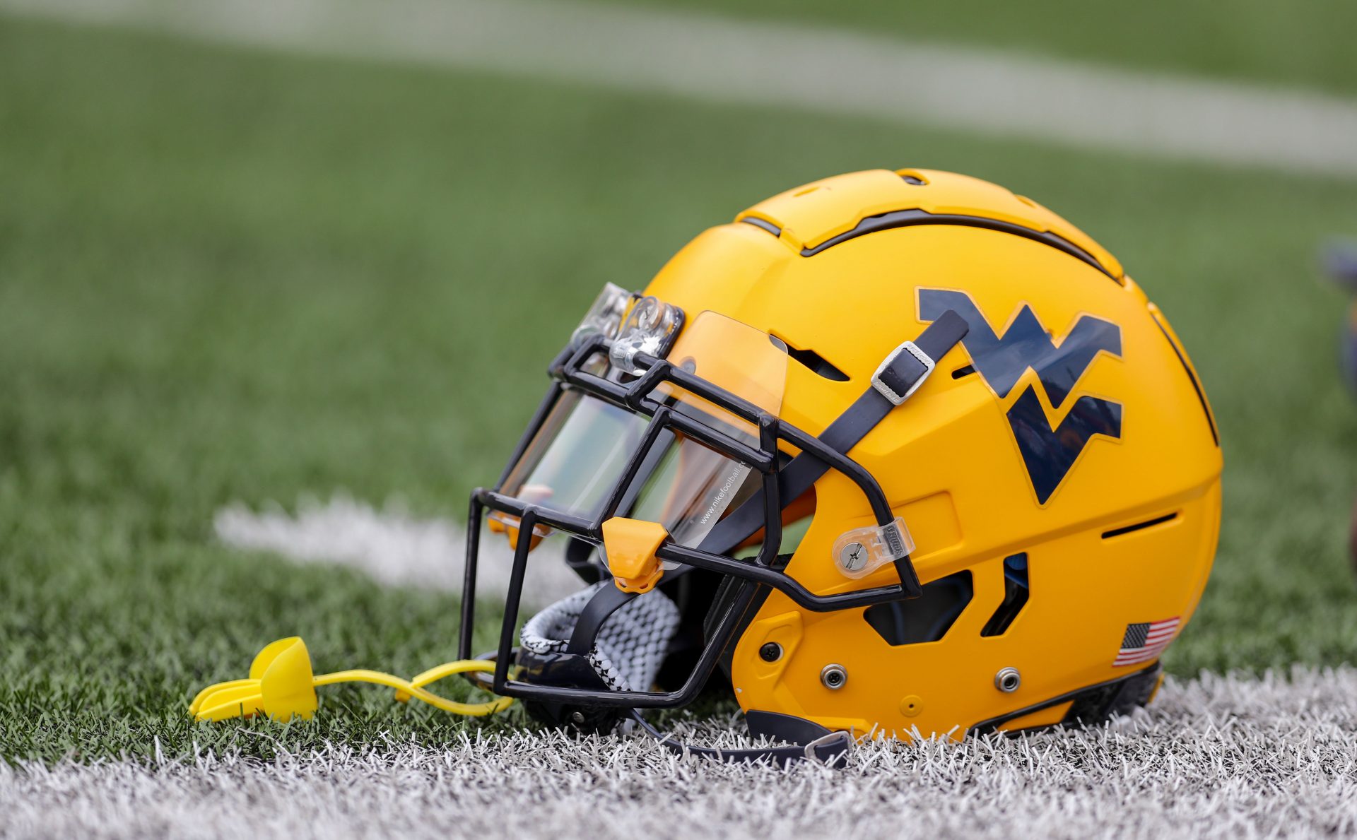 A West Virginia Mountaineers helmet on the field during warmups at Mountaineer Field at Milan Puskar Stadium.