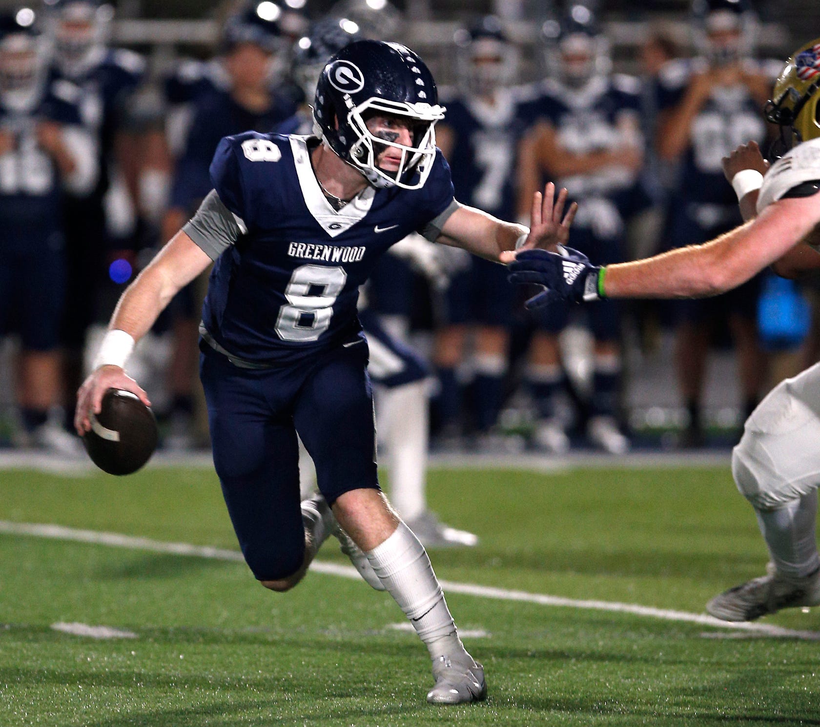 Greenwood's Kane Archer fends off a Pulaski Academy defender during the 5A West Conference game on Oct. 28 at Smith Robinson Stadium.