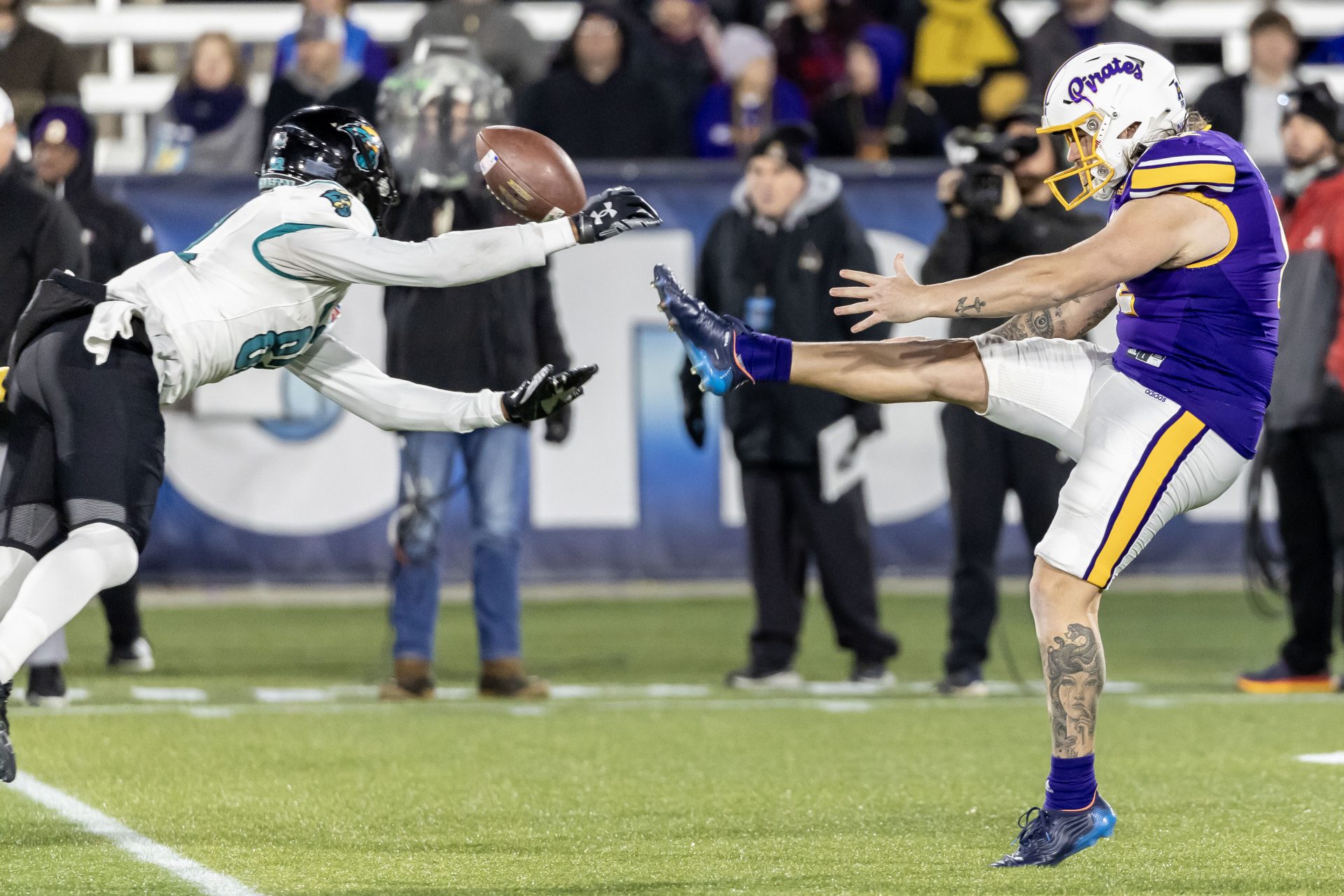 Coastal Carolina Chanticleers special teamer Jameson Tucker (82) blocks a punt from East Carolina Pirates punter Luke Larsen (12) in the 2022 Birmingham Bowl at Protective Stadium.