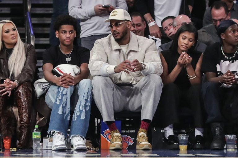 Former NBA player Carmelo Anthony (r) sits with his son Kiyan Anthony (l) at the game between the Boston Celtics and the New York Knicks at Madison Square Garden.