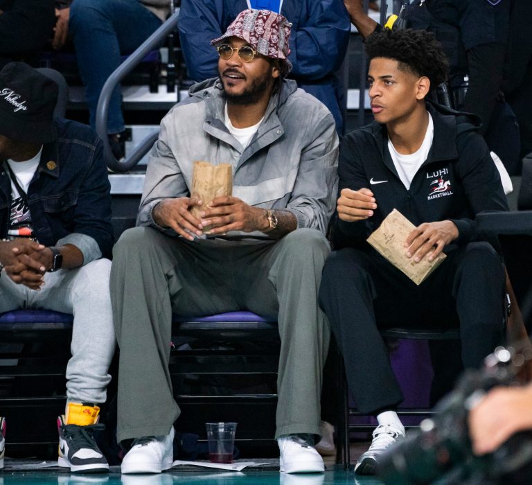 Carmelo Anthony and his son, Kiyan, watch the Don Bosco Prep Ironmen compete against the McEachern Indians in a game during the 50th annual City of Palms Classic at Suncoast Credit Union Arena in Fort Myers on Tuesday, Dec. 19, 2023. Kiyan Anthony and the Long Island Luthern Crusaders defeated Westminster Academy earlier in the day.