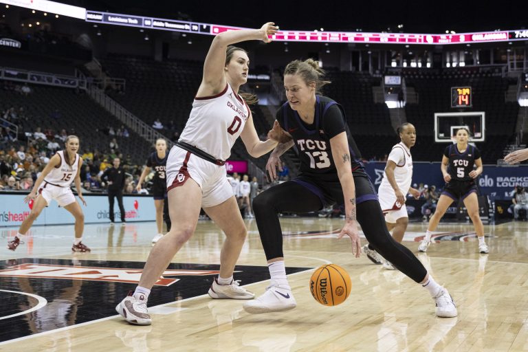 Texas Christian Horned Frogs forward Sedona Prince (13) handles the ball while being guarded by Oklahoma Sooners center Beatrice Culliton (0) during the first half at T-Mobile Center.