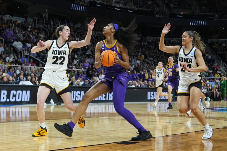 LSU Lady Tigers forward Angel Reese (10) controls the ball against Iowa Hawkeyes guard Caitlin Clark (22) and guard Gabbie Marshall (24) in the first half in the finals of the Albany Regional in the 2024 NCAA Tournament at MVP Arena.