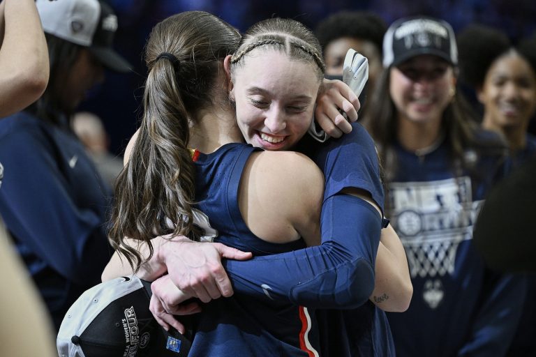 UConn Huskies guard Paige Bueckers (5) celebrates with guard Nika Muhl (10) after beating the USC Trojans in the finals of the Portland Regional of the NCAA Tournament at the Moda Center.