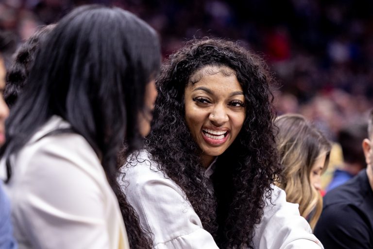 LSU forward Angel Reese and forward Amani Bartlett watch the game between the New Orleans Pelicans and the Orlando Magic during the first half at Smoothie King Center.
