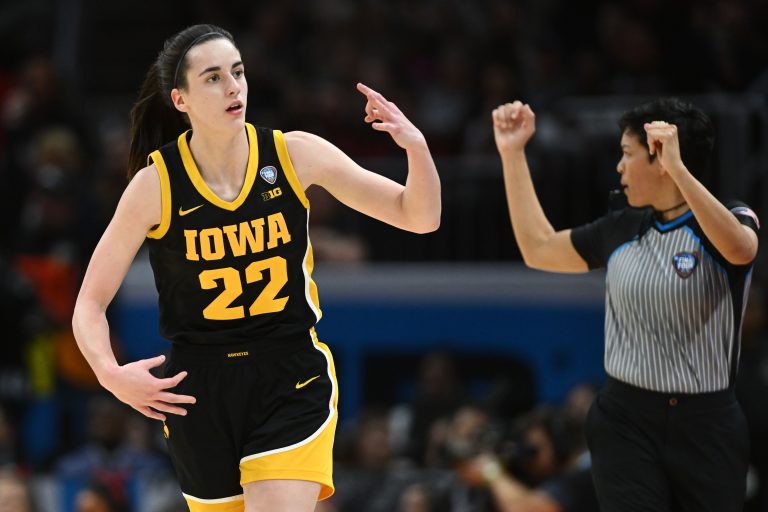 Iowa Hawkeyes guard Caitlin Clark (22) reacts after making a three point basket against the South Carolina Gamecocks in the finals of the Final Four of the womens 2024 NCAA Tournament at Rocket Mortgage FieldHouse.