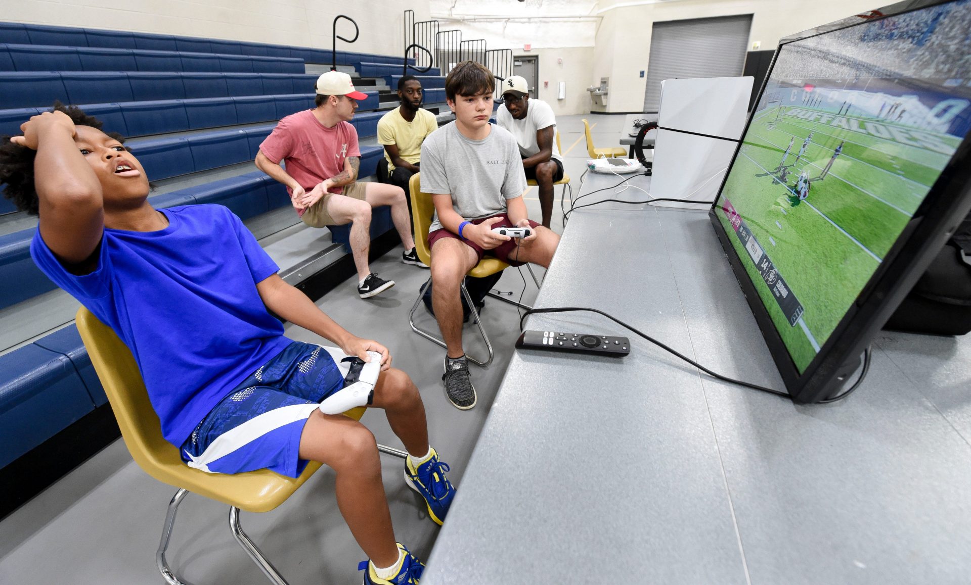 Andrew Carter reacts as he and Rylee Pierson play each other on the new EA Sports College Football 25 video game at the McDonald Hughes Center in Tuscaloosa.