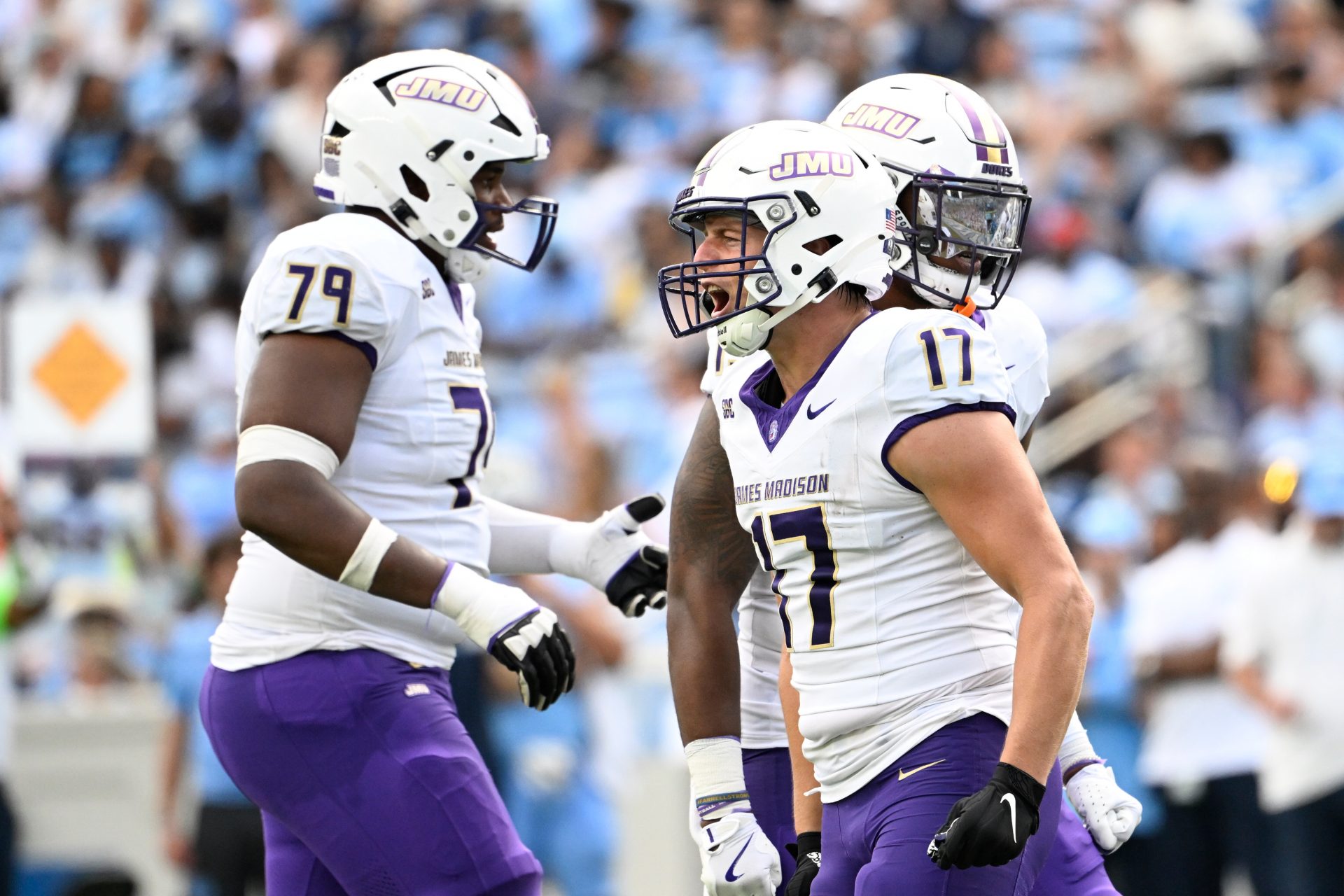 James Madison Dukes tight end Taylor Thompson (17) reacts with offensive lineman Joseph Simmons (79) after scoring a touchdown in the second quarter at Kenan Memorial Stadium.