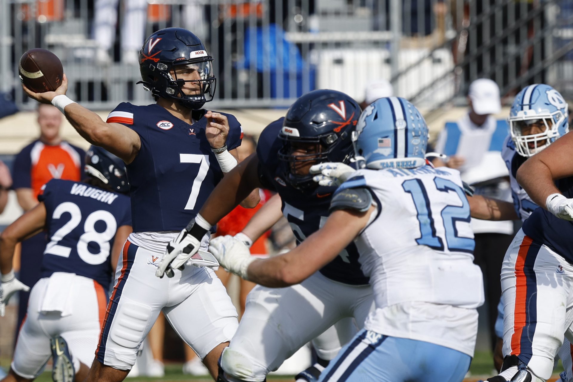 Virginia Cavaliers quarterback Tony Muskett (7) passes the ball s North Carolina Tar Heels defensive lineman Beau Atkinson (12) chases during the second half at Scott Stadium.