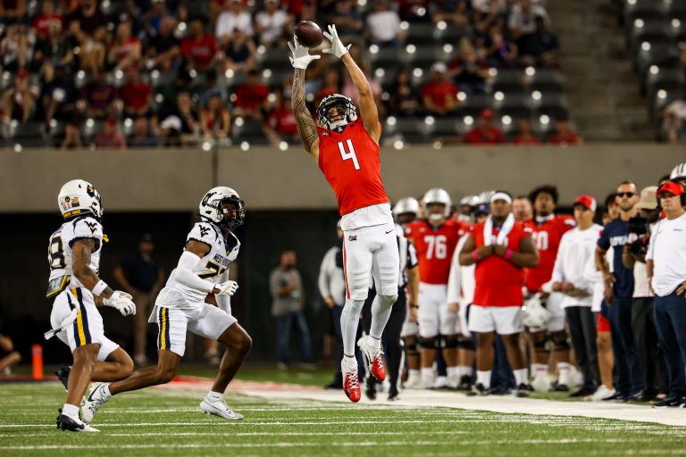 Arizona Wildcats wide receiver Tetairoa McMillan (4) attempts to catch the ball during the third quarter against the West Virginia Mountaineers at Arizona Stadium.