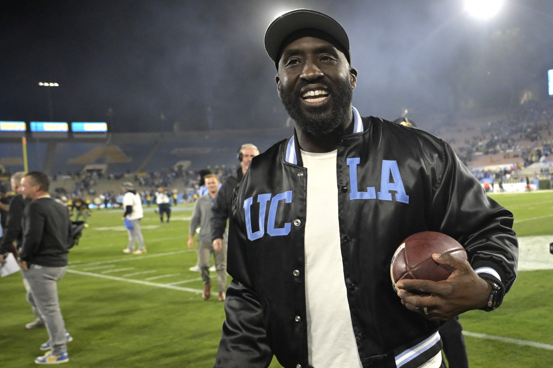 UCLA Bruins head coach DeShaun Foster leaves the field with the game ball after defeating the Iowa Hawkeyes at the Rose Bowl.