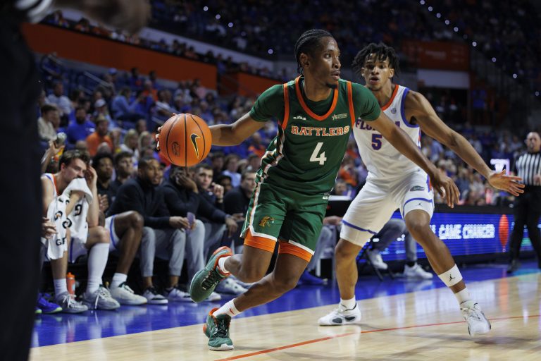 Sterling Young (4) dribbles the ball past Florida Gators guard Will Richer (5) during the first half at Exactech Arena at the Stephen C. O'Connell Center.